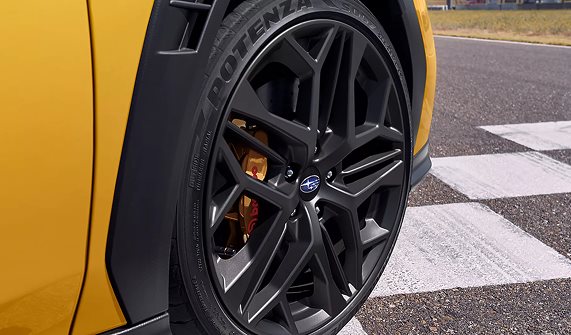 WRX Series.Yellow Brembo 6-piston front brake caliper with cross-drilled rotor