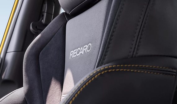 WRX Series.Yellow interior cabin with Recaro seats, yellow stitching accents, and red STI start button