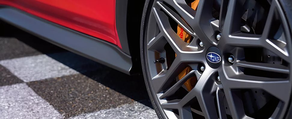 WRX tS gold-finish Brembo 6-piston front caliper and ventilated cross-drilled rotor close-up