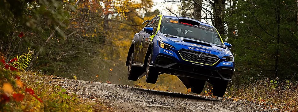 Subaru Motorsports USA WRX rally car in action representing 19 national rally championship titles