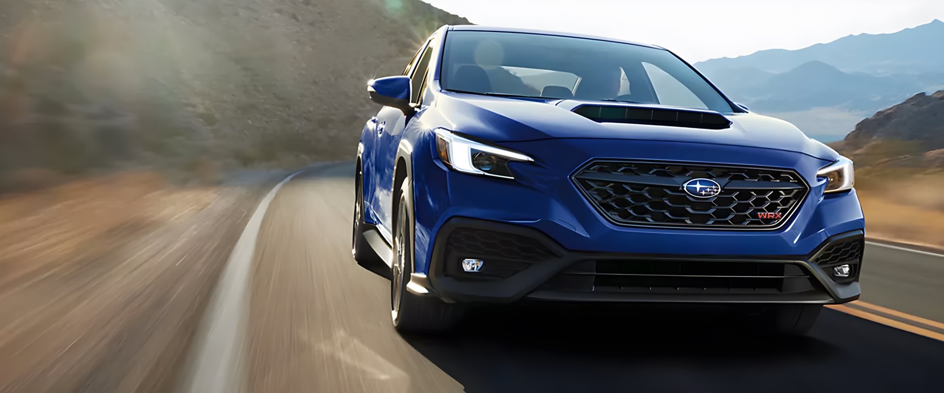 2026 Subaru WRX sports sedan driving on a desert road near Prescott, Arizona
