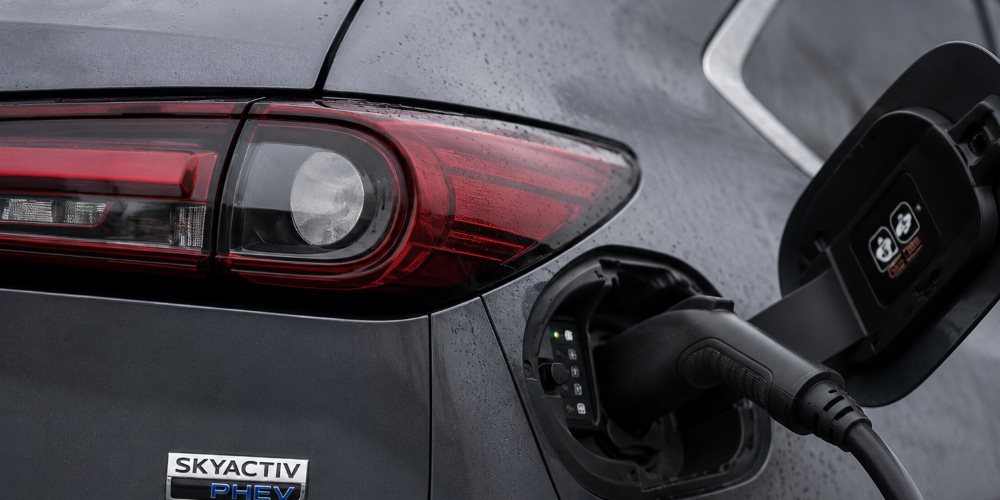 Mazda hybrid badge and charging port on a Mazda PHEV