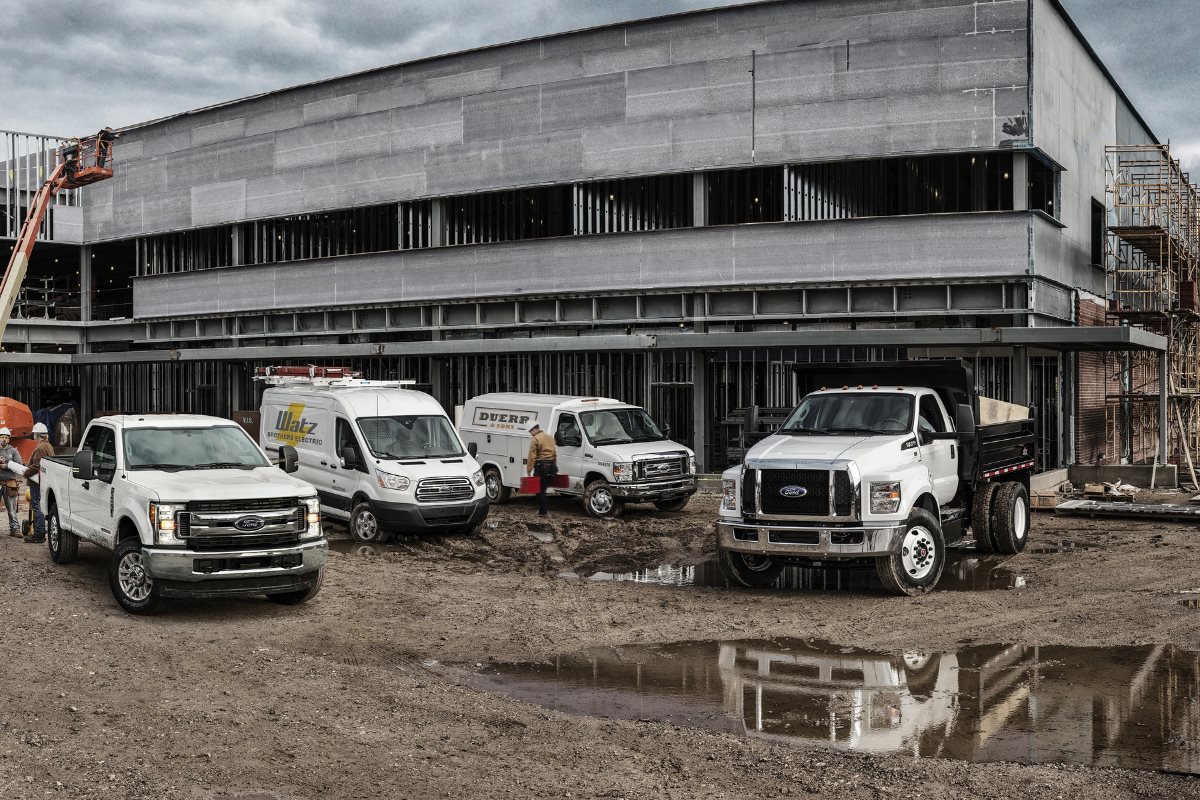 Ford commercial vehicles at a construction site, highlighting work truck and van options for businesses looking to replace or expand their fleet.