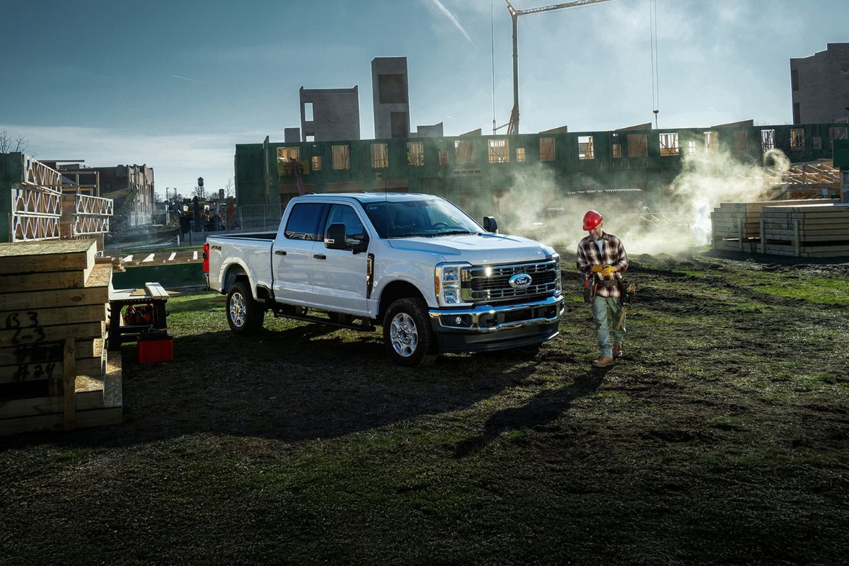 Ford Super Duty work truck at a construction jobsite with a contractor, highlighting the importance of dependable commercial vehicles for growing businesses.