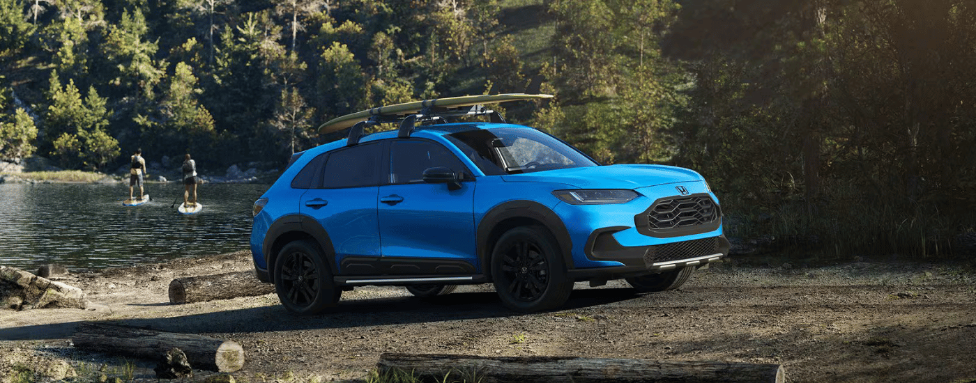 Blue 2027 Honda HR-V parked by a lake