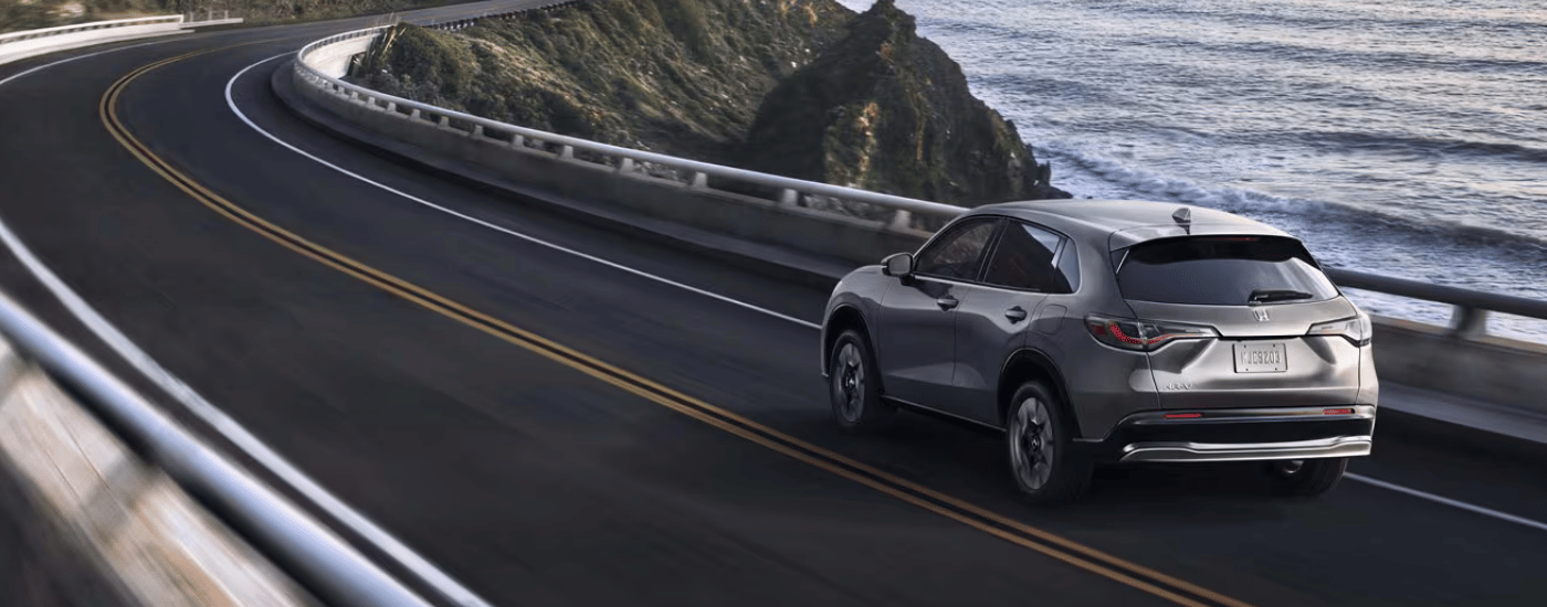 Grey 2027 Honda HR-V driving on a winding road