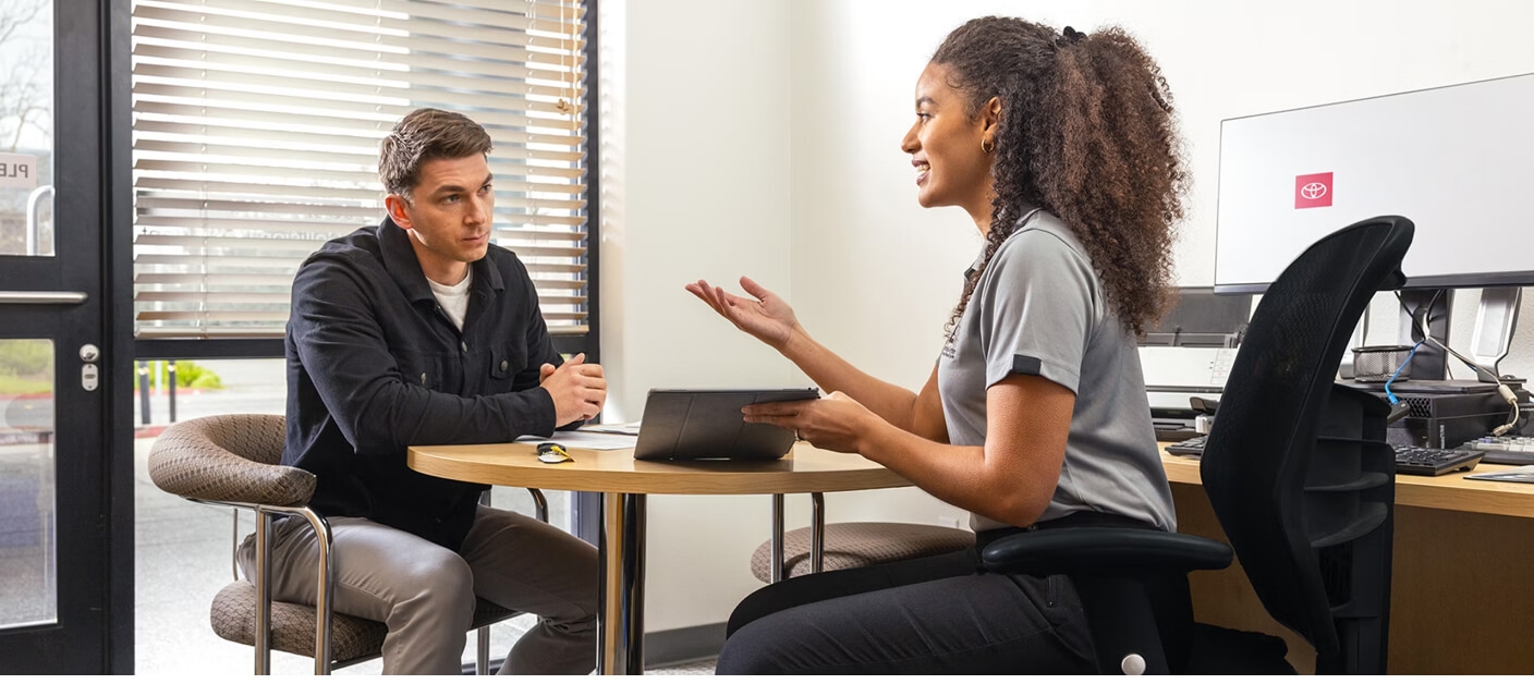 Toyota Services consultant explaining financing options to a customer.