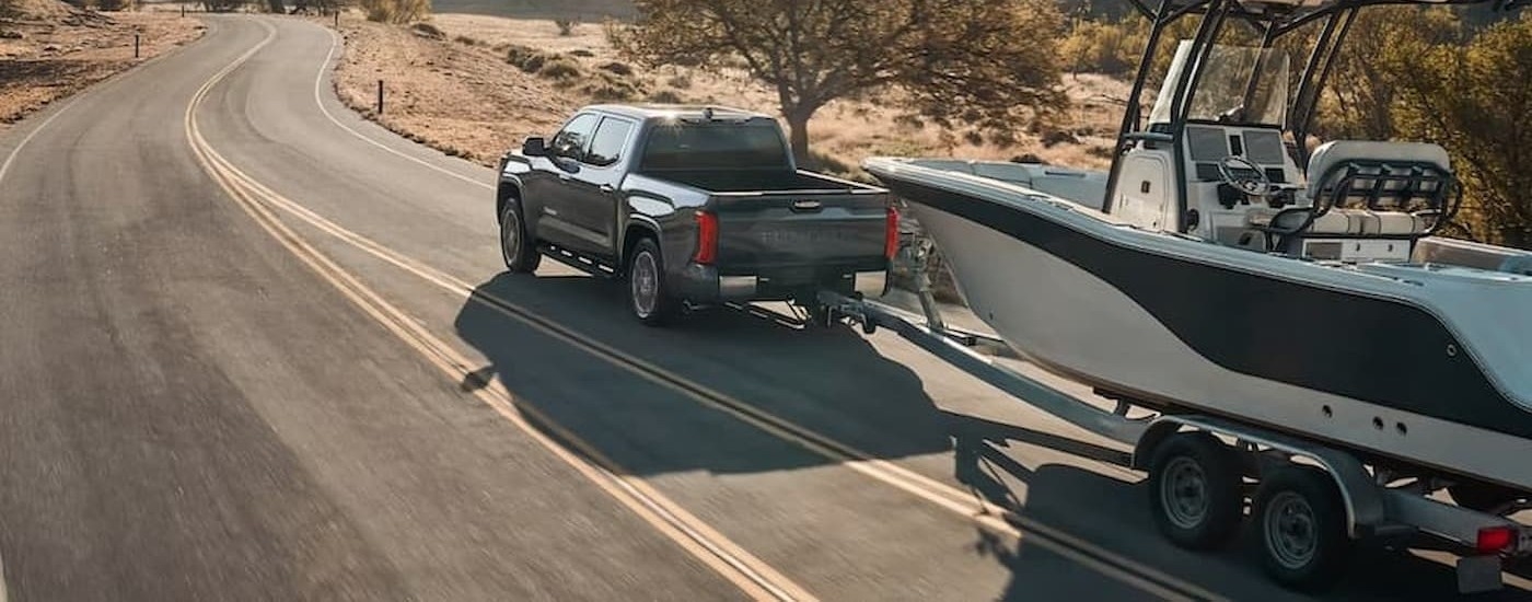 A gray 2026 Toyota Tundra towing a boat.