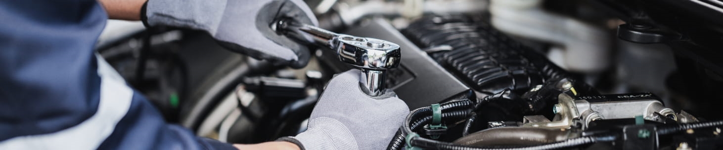 Automotive technician using a wrench to service a Toyota vehicle near Antioch, CA.