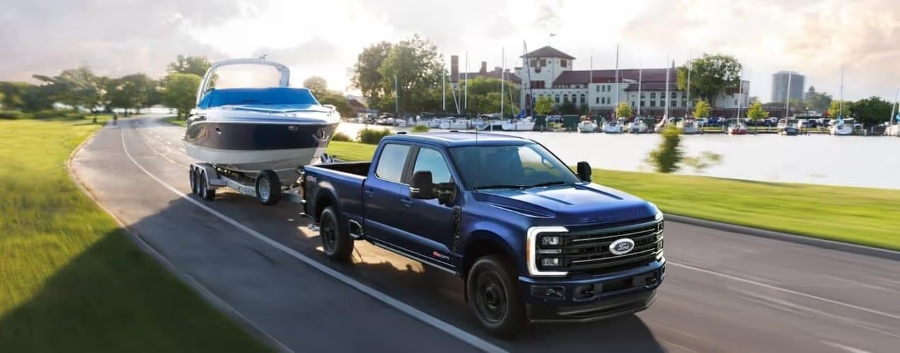 A blue 2026 Ford Super Duty towing a boat