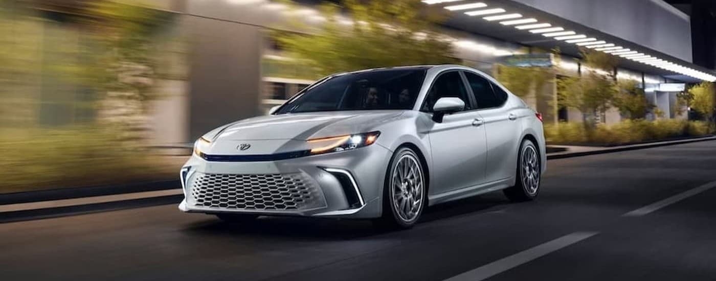 A silver 2026 Toyota Camry driving in a city.