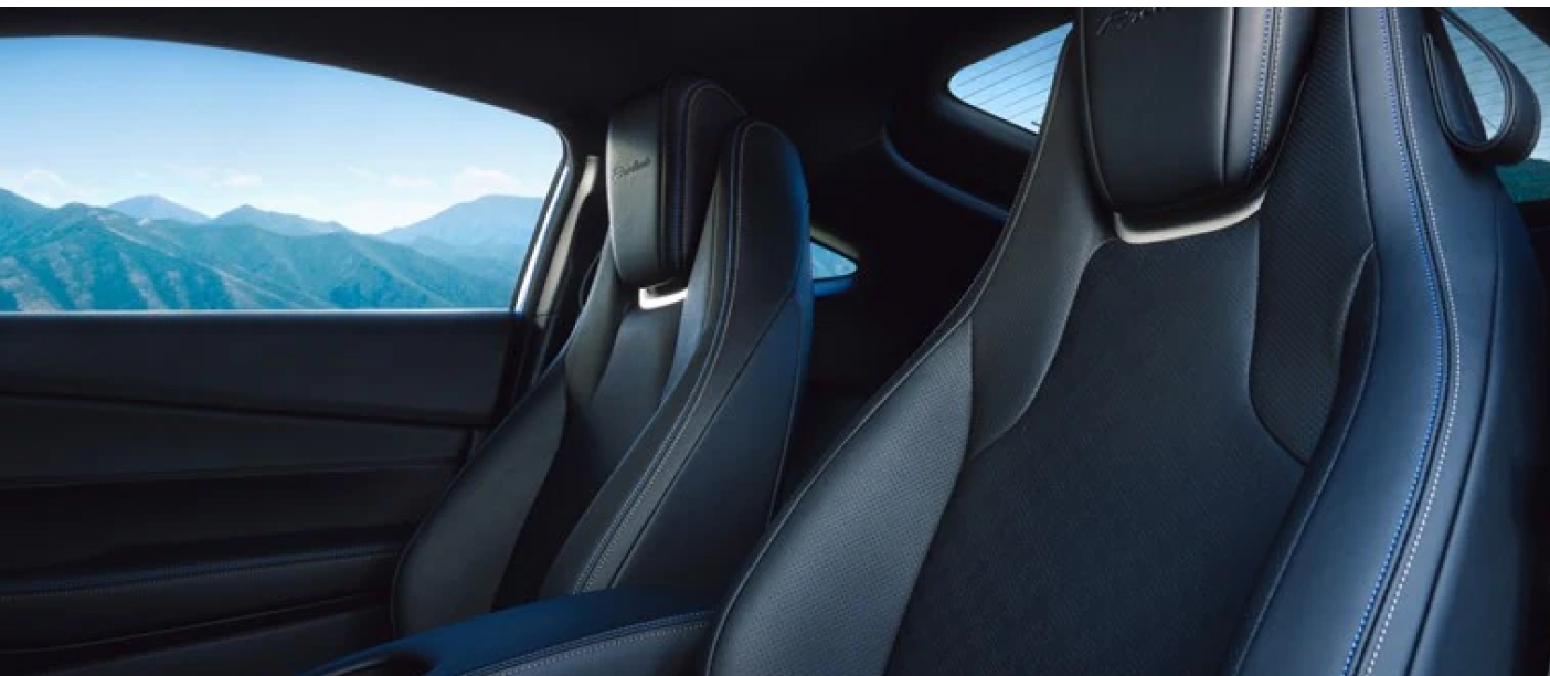 2026 Honda Prelude interior showcasing two sleek leather bucket seats with white stitching and set against a backdrop of scenic mountains through the window.