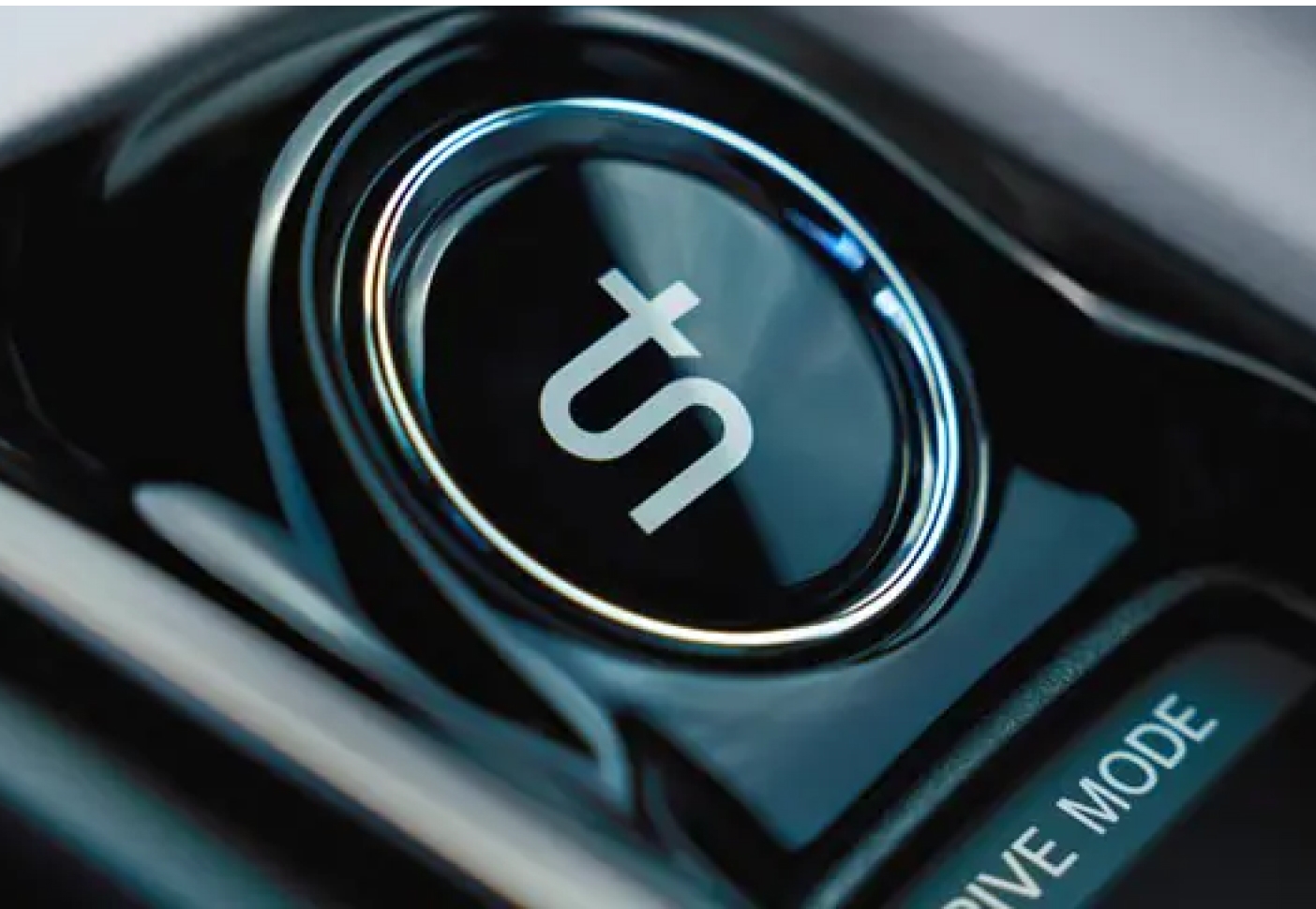 Close-up of a shiny black car drive mode selector with a metallic ring.