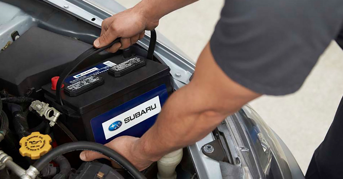 Subaru parts technician installing a battery
