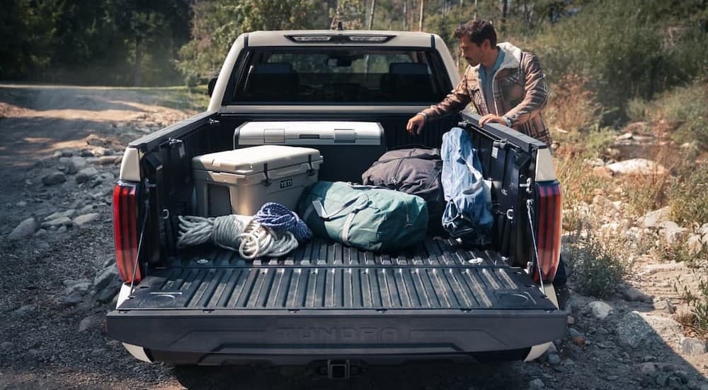 Camping gear in the bed of a white 2026 Toyota Tundra.