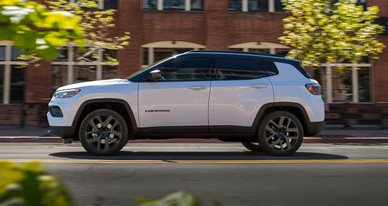 Jeep SUV driving down the street