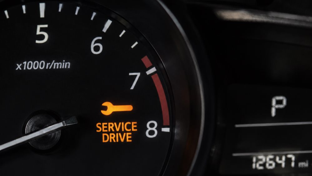Mazda instrument cluster showing the maintenance wrench indicator