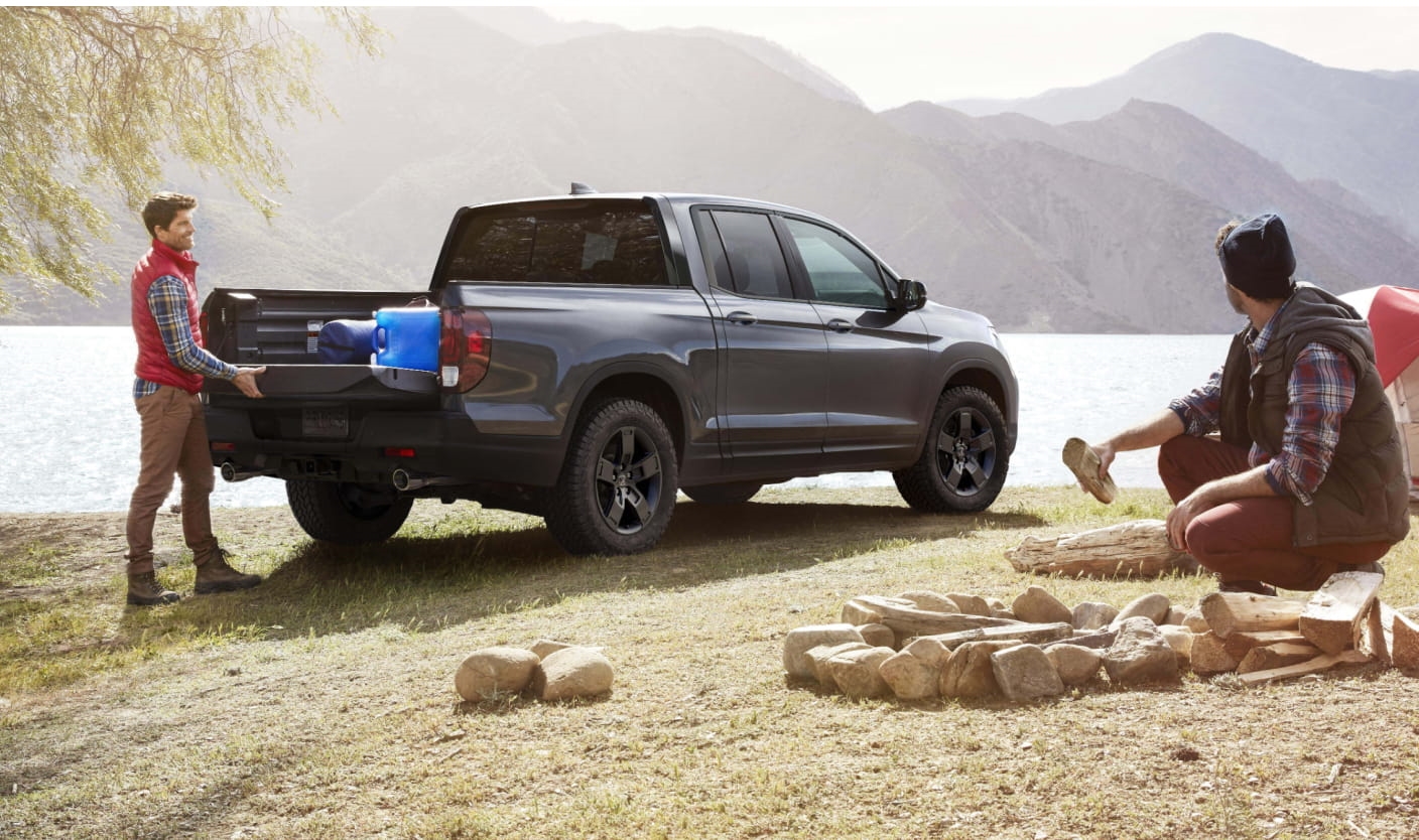 2026 Honda Ridgeline is parked by a lakeside.