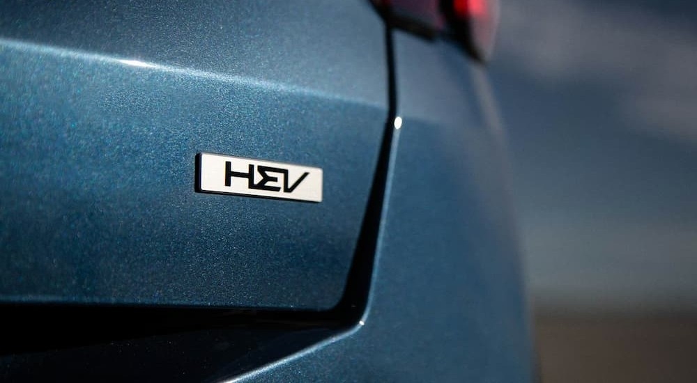 A badge on a blue 2026 Kia Sorento PHEV.
