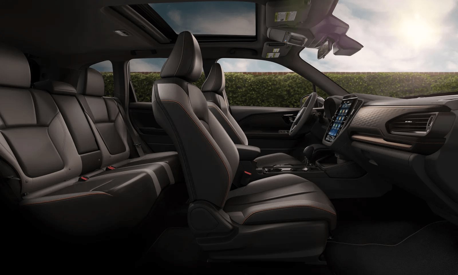 The 2026 Subaru Forester interior, showing upright seats, wide door openings, a large central touchscreen, and a clear view out through tall glass