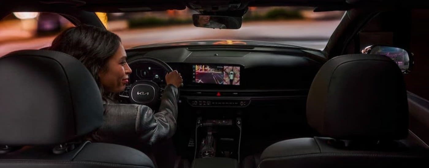 A person driving in a 2026 Kia Sorento.