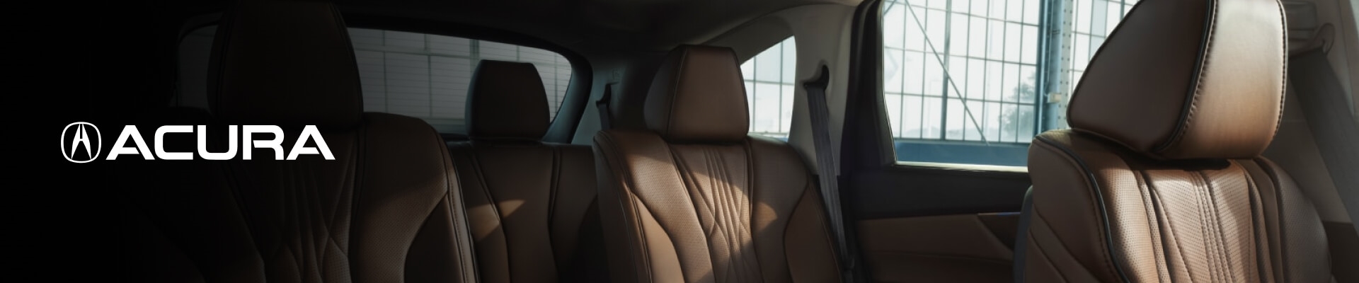 Interior view of an Acura MDX in a dark warehouse setting.