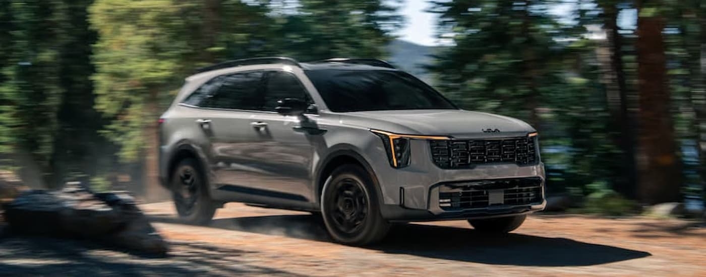 A tan 2025 Kia Sorento Plug-In Hybrid off-roading on a trail