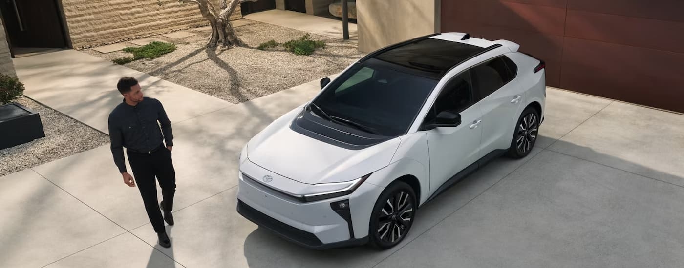 High view of a white 2026 Toyota bZ parked on a driveway.