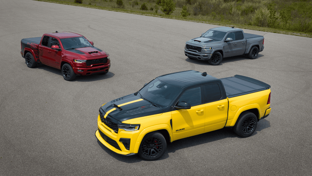 See our RAM inventory at Arrigo RAM in Margate FL featuring red, gray, and yellow RAM pickup trucks with black sport wheels and contrast hood stripes parked on a test track