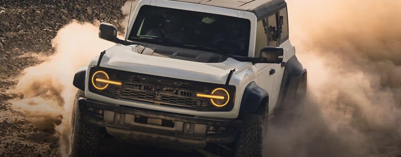 White 2026 Ford Bronco Raptor kicking up dust