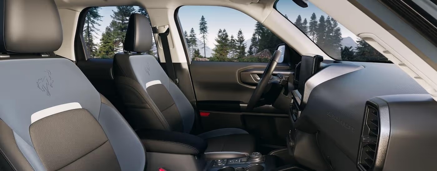 The black and blue interior and dash are shown in a 2025 Ford Bronco Sport.