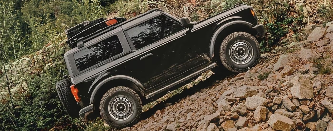 Black 2026 Ford Bronco driving up a steep hill