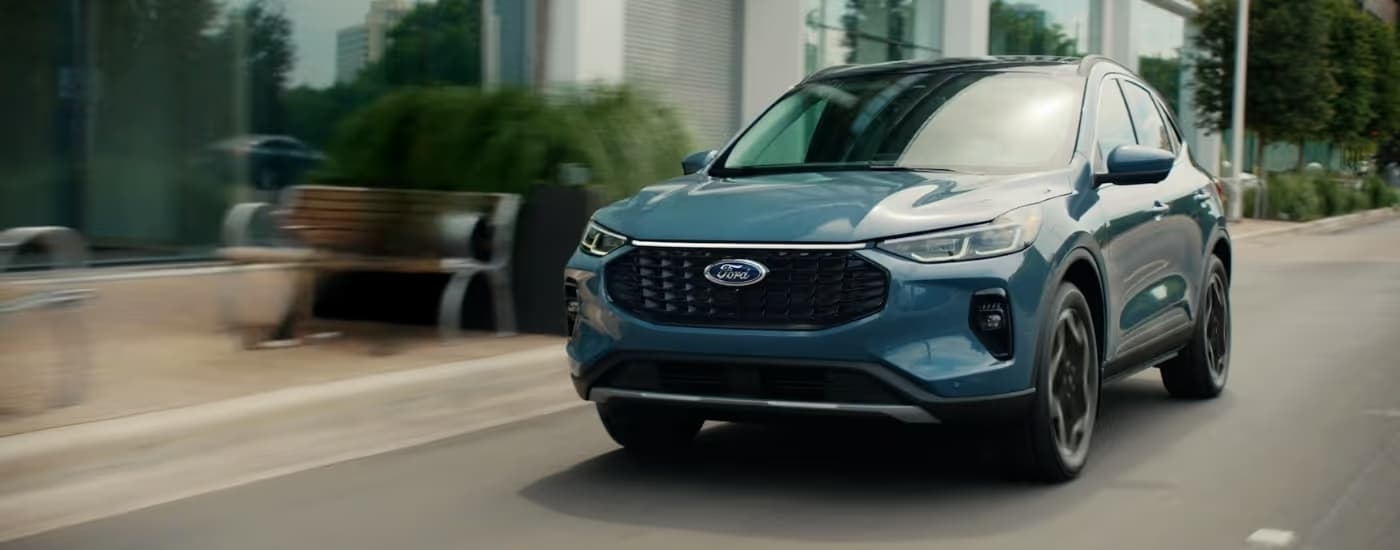 Blue 2026 Ford Escape driving on a city street