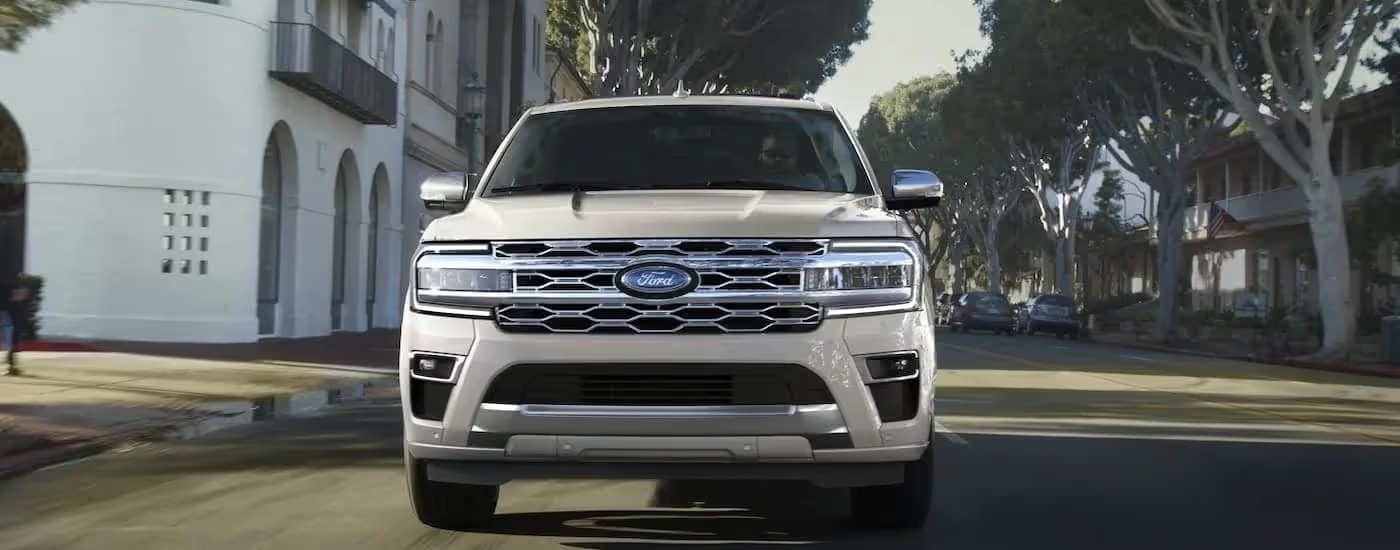 A white 2022 Ford Expedition is shown from the front after leaving a dealer.