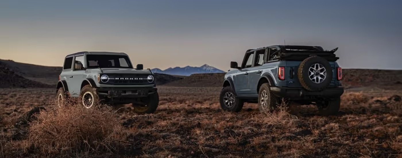 Two blue 2026 Ford Broncos parked side by side