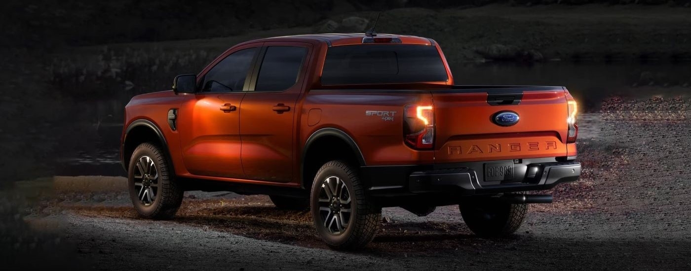 Orange 2024 Ford Ranger Sport parked off-road at night