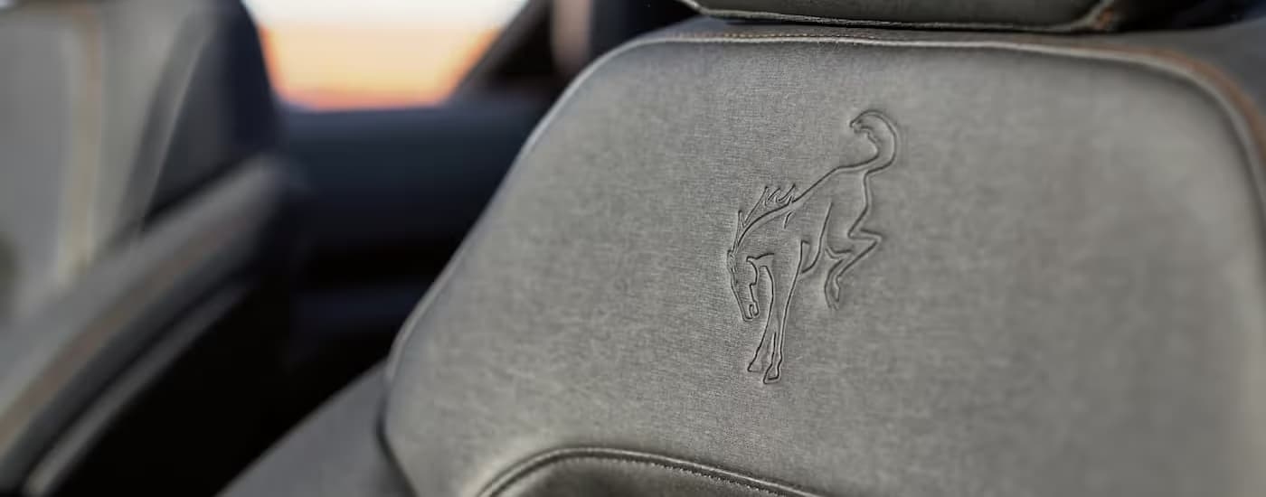 Close-up of the Bronco badge on the gray interior seating in a 2026 Ford Bronco.