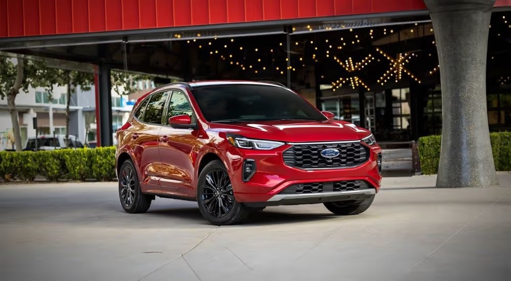 Red 2026 Ford Escape parked in front of a store.
