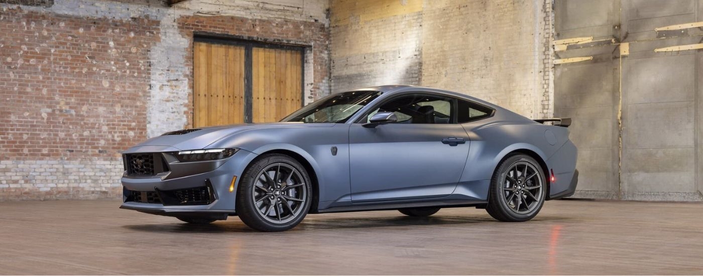 Silver 2024 Ford Mustang Dark Horse parked in front of a brick wall