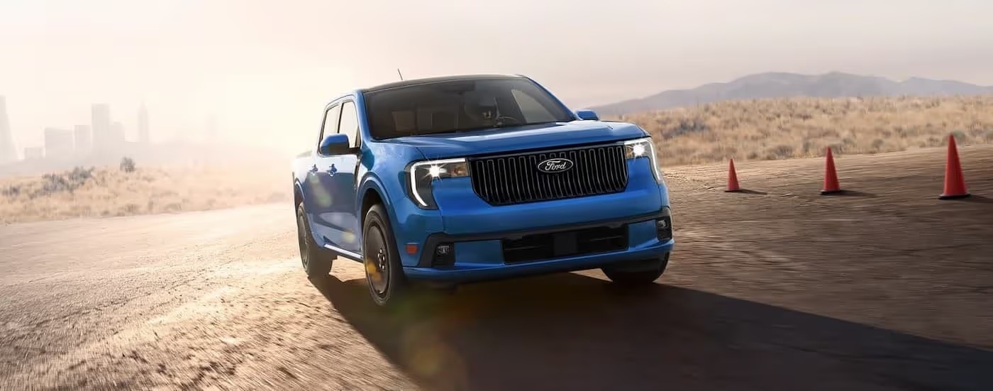 A blue 2025 Ford Lobo racing on a track.