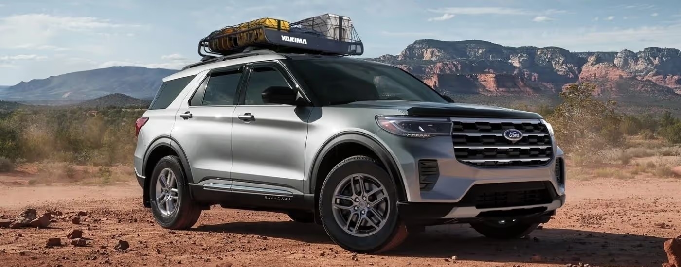A silver 2025 Ford Explorer Active is parked off-road.