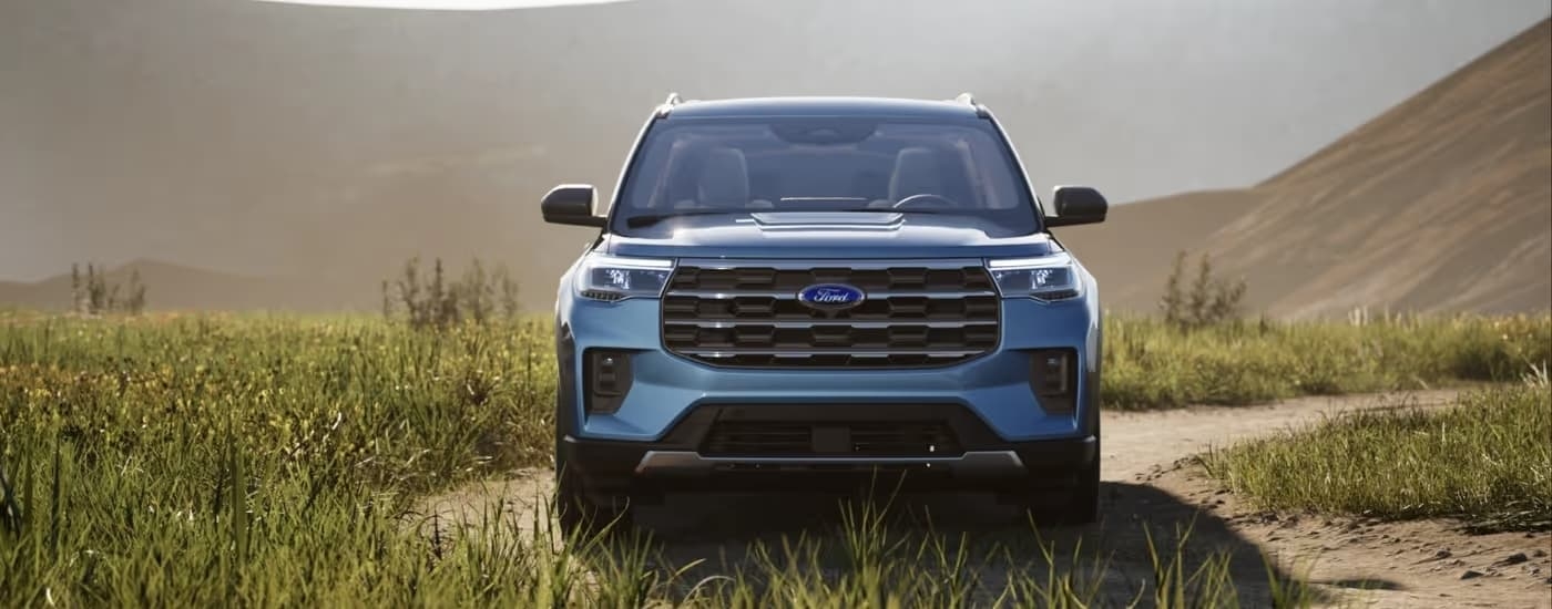 A blue 2025 Ford Explorer Active parked off-road