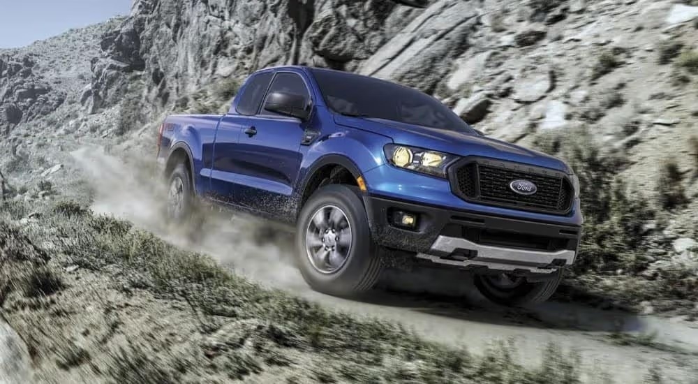 A blue 2023 Ford Ranger XL STX FX4 is shown driving on a trail after leaving a Dunwoody Ford dealer.