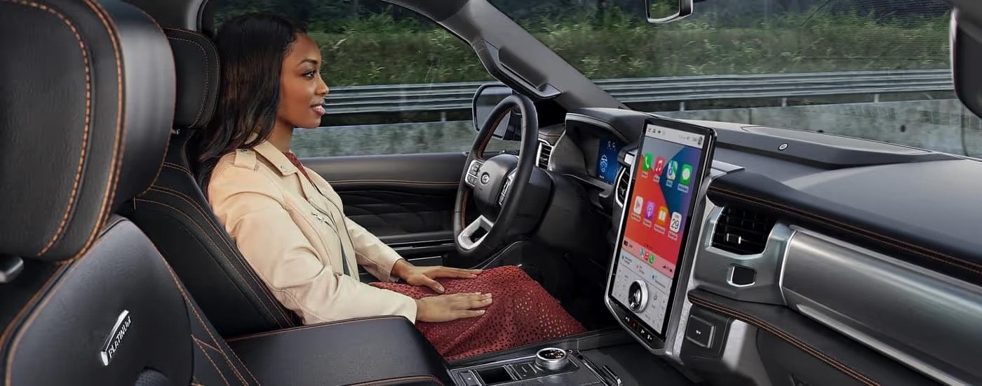 A woman using the Ford BlueCruise feature in a 2024 Ford Expedition Platinum.