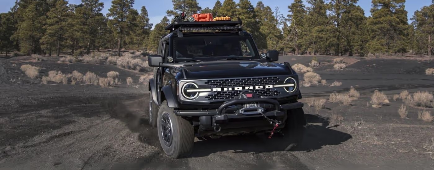 A black 2025 Ford Bronco off-roading on sand