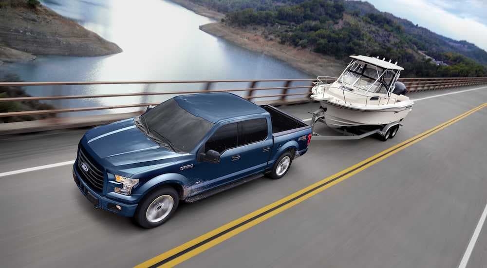 Blue 2017 Ford F-150 driving over a bridge