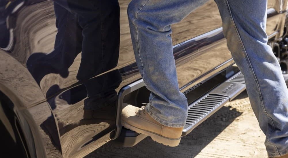 Person stepping on the running board of a 2023 Ford F-250 XL STX