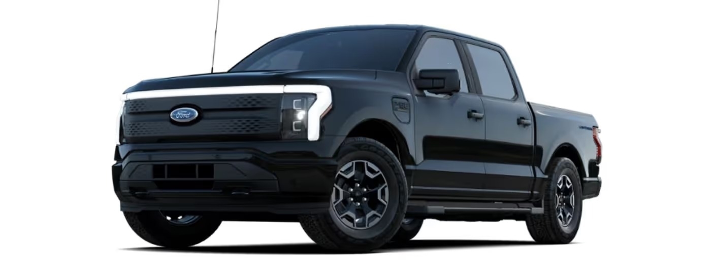 A black 2024 Ford F-150 Lightning XLT angled left.