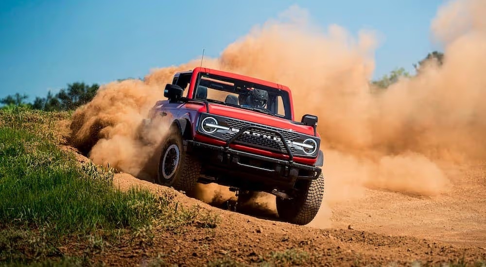 A red 2021 Ford Bronco WildTrack is shown from the fornt at an angle.