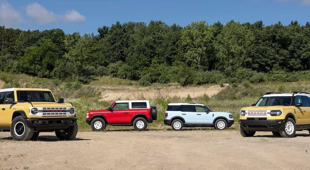 2 2023 Ford Bronco Heritage Editions and Two 2023 Ford Bronco Sport Heritage Editions are parked.